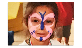Child with a butterfly painted on their face