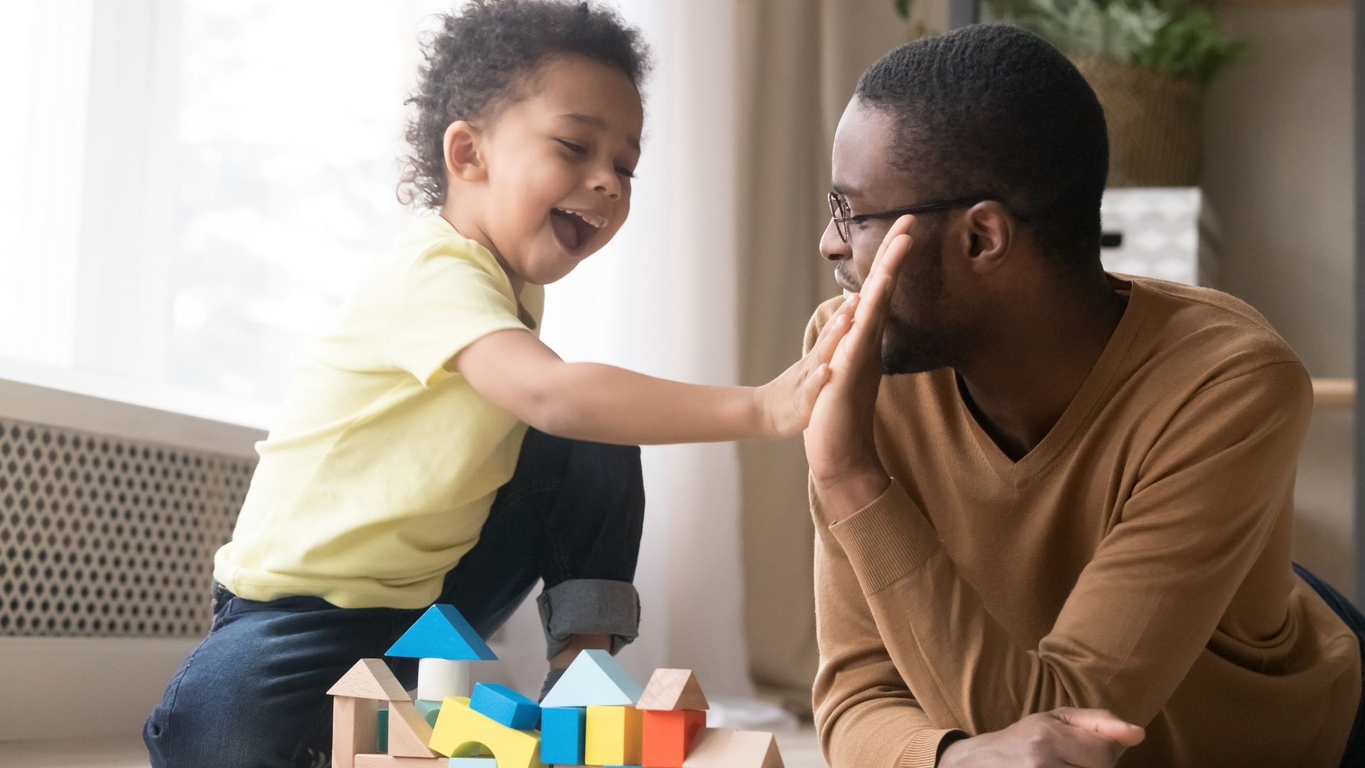 Image of Child and Parent doing high five