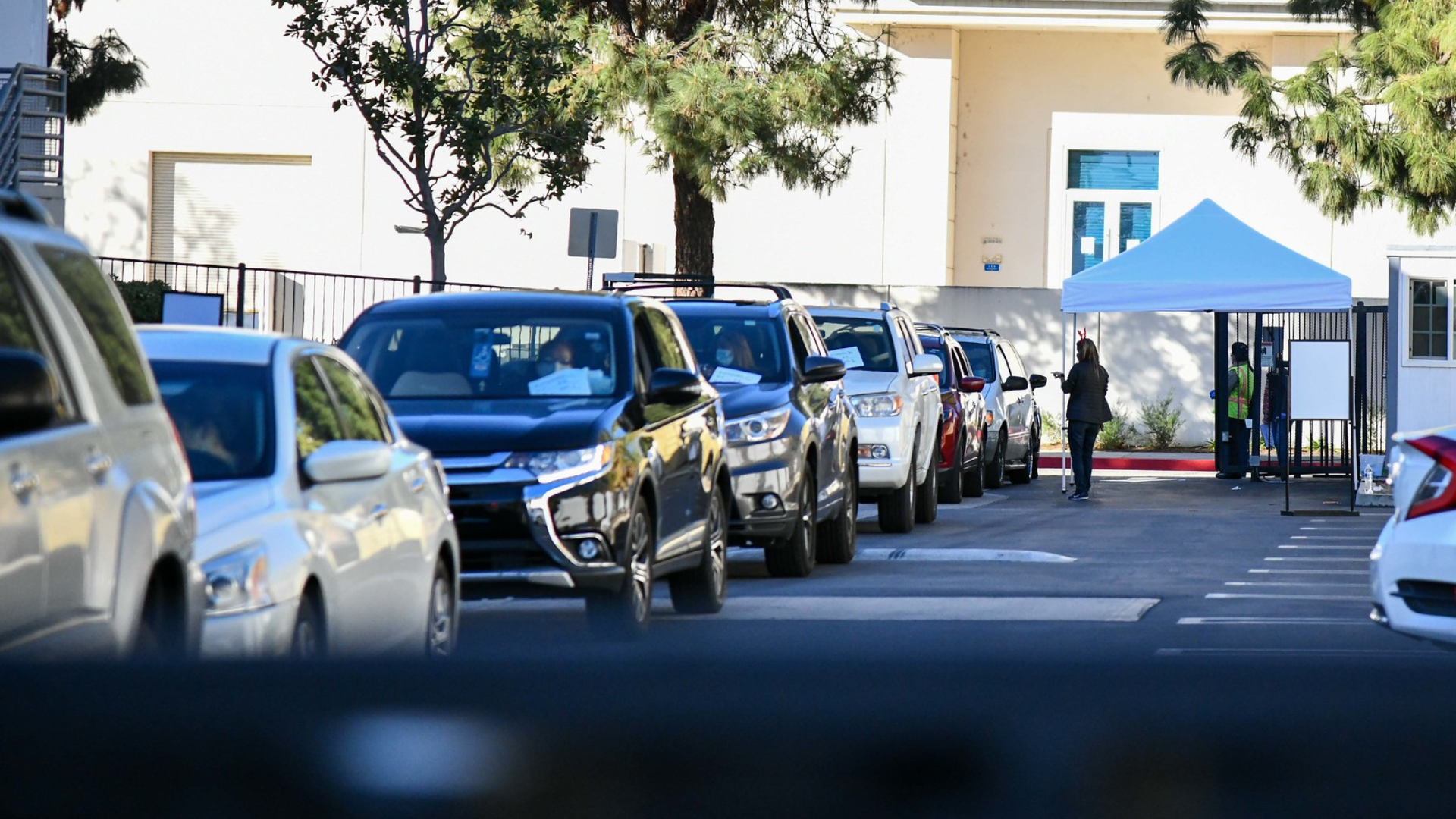 An image of a line of cars at a previous Holiday Book and Toy Giveaway drive thru event at our Chatsworth location.