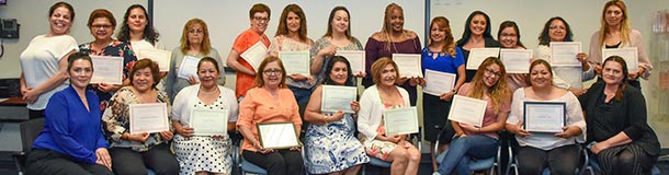 Group of child care providers holding certificates