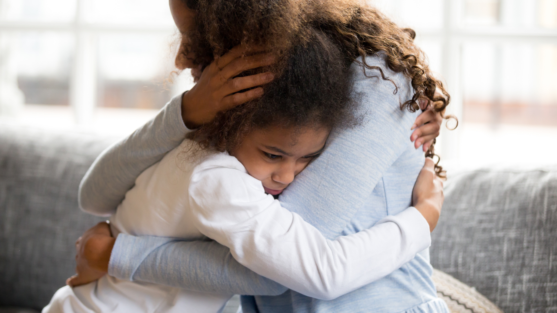 An image focused on a daughter hugging their mother.