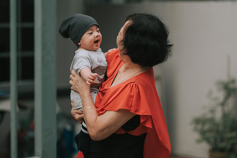 Grandmother and infant laughing - Family, Friend or Neighbor