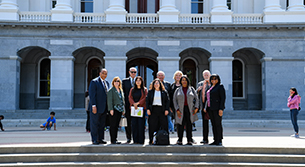 Board of Directors standing in front of California capitol.
